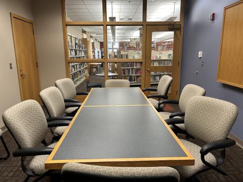 A conference table with chairs around it.